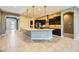 Open kitchen with granite island and stainless steel appliances at 7260 Fruitful Harvest Ave, Las Vegas, NV 89131
