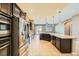 Modern kitchen, stainless steel appliances and granite island at 7260 Fruitful Harvest Ave, Las Vegas, NV 89131