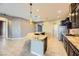 Island kitchen with granite countertops and dark wood cabinets at 7260 Fruitful Harvest Ave, Las Vegas, NV 89131