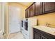 Laundry room with washer, dryer, cabinets and utility sink at 7260 Fruitful Harvest Ave, Las Vegas, NV 89131