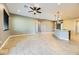 Open living room and kitchen with tile flooring and a ceiling fan at 7260 Fruitful Harvest Ave, Las Vegas, NV 89131