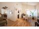 Dining area with hardwood floors, a glass table, and a view of the kitchen at 7670 Isley Ave, Las Vegas, NV 89147