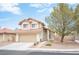 Two-story house with tan exterior, tile roof, and attached garage at 7670 Isley Ave, Las Vegas, NV 89147