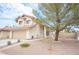 Two-story house with tan exterior, tile roof, and attached garage; landscaped yard at 7670 Isley Ave, Las Vegas, NV 89147