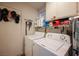 Laundry room with washer, dryer, and storage shelves at 7670 Isley Ave, Las Vegas, NV 89147