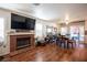 Living room with brick fireplace, hardwood floors, and dining area at 7670 Isley Ave, Las Vegas, NV 89147