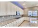 Modern kitchen with white cabinets, granite counters, and gas cooktop at 7926 Elk Mountain St, Las Vegas, NV 89113