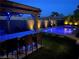 Night view of a patio with pool and bar at 7926 Elk Mountain St, Las Vegas, NV 89113