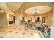 A light-filled upper landing with a chandelier and curved wrought iron railings at 9101 Alta Dr # 1802, Las Vegas, NV 89145