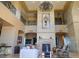 Two-story living room with a grand fireplace and chandelier at 9101 Alta Dr # 1802, Las Vegas, NV 89145