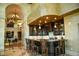 Dark wood wet bar with granite countertop and seating at 9101 Alta Dr # 1802, Las Vegas, NV 89145