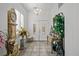 Bright entryway with tiled floors, double doors, and antique furniture at 9124 Worsley Park Pl, Las Vegas, NV 89145