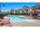 Community pool with lounge chairs, umbrellas, and spa at 9124 Worsley Park Pl, Las Vegas, NV 89145