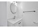A well-lit half bathroom with a modern sink, mirror, and towel rack at 9247 Tulip Trestle Ave, Las Vegas, NV 89148