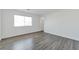 Bright bedroom features a window and stylish gray wood-look flooring at 9247 Tulip Trestle Ave, Las Vegas, NV 89148