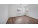 Bright bedroom features wood-look flooring and natural light from two windows at 9247 Tulip Trestle Ave, Las Vegas, NV 89148