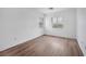 Bright bedroom features wood-look flooring and natural light from two windows at 9247 Tulip Trestle Ave, Las Vegas, NV 89148