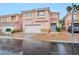 Charming two-story home featuring a blue front door and a well-maintained, low maintenance landscaped yard at 9247 Tulip Trestle Ave, Las Vegas, NV 89148