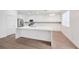 A modern kitchen with white cabinets, stainless steel appliances, and a center island with a marble countertop at 9247 Tulip Trestle Ave, Las Vegas, NV 89148