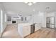 Open-concept kitchen with stainless appliances, a large island, and hardwood floors connected to the living room at 9247 Tulip Trestle Ave, Las Vegas, NV 89148