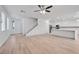 Bright and airy open-concept living space with hardwood floors, a staircase, and an adjacent kitchen at 9247 Tulip Trestle Ave, Las Vegas, NV 89148