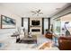 Living room with sectional sofa, fireplace, and access to patio at 107 Reflection Cove Dr, Henderson, NV 89011