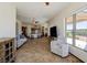 Living room with kitchen view, tiled floor and large windows at 1085 Cameron Ave, Logandale, NV 89021