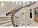 Elegant curved staircase with ornate railing at 12056 Royal Dolnoch Ct, Las Vegas, NV 89141