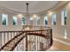 Open upper hallway with large windows and a chandelier at 12056 Royal Dolnoch Ct, Las Vegas, NV 89141