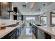 Modern kitchen with dark cabinetry, stainless steel appliances, and expansive island at 12445 Iron Bluff Ave, Las Vegas, NV 89138