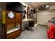 Well-organized garage featuring a workbench, tool storage, and a red car parked inside at 206 Pebble Creek Hts, Mesquite, NV 89027