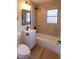 Updated bathroom with light beige tile and a modern vanity at 210 Nebraska Ave, Henderson, NV 89015