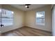 Bedroom with two windows, wood floors, and a ceiling fan at 210 Nebraska Ave, Henderson, NV 89015