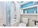 Clean bathroom with bathtub, toilet and floating shelves at 2225 Chandler Ranch Pl, Laughlin, NV 89029