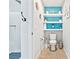 Clean bathroom with toilet, floating shelves, and shower at 2225 Chandler Ranch Pl, Laughlin, NV 89029
