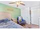 Bright bedroom with a queen bed, recliner, and double door closet at 2225 Chandler Ranch Pl, Laughlin, NV 89029