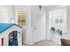 Bright entryway with white door, gray walls, and a view into a sitting area at 2225 Chandler Ranch Pl, Laughlin, NV 89029