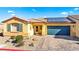 Single-story home with solar panels, desert landscaping, and a paved driveway at 2225 Chandler Ranch Pl, Laughlin, NV 89029