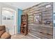 Living room with wood-paneled accent wall, wooden cabinet, and Gathering photos at 2225 Chandler Ranch Pl, Laughlin, NV 89029