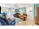 Spacious living room with teal accent wall, ceiling fan, and comfortable seating at 2225 Chandler Ranch Pl, Laughlin, NV 89029