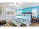 Main bedroom with a light teal accent wall, king-size bed, and wood flooring at 2225 Chandler Ranch Pl, Laughlin, NV 89029