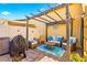 Relaxing patio with pergola, seating, and grill at 2225 Chandler Ranch Pl, Laughlin, NV 89029