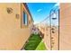 Landscaped side yard with artificial turf and decor at 2225 Chandler Ranch Pl, Laughlin, NV 89029