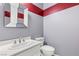 Powder room with gray walls, red accent stripes and white vanity at 291 Calgrove St, Las Vegas, NV 89138