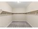 Spacious walk-in closet with wood shelving and gray carpeting at 291 Calgrove St, Las Vegas, NV 89138