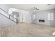 Living room with light gray walls, hardwood floors, and a fireplace at 291 Calgrove St, Las Vegas, NV 89138