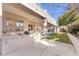 Landscaped backyard with spacious patio, built-in grill, and grassy area at 31 Castle Creek Ct, Las Vegas, NV 89148