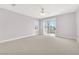 Bright bedroom with sliding door to balcony, ceiling fan, and neutral decor at 31 Castle Creek Ct, Las Vegas, NV 89148