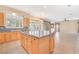 Kitchen island with granite countertops and light wood cabinets at 31 Castle Creek Ct, Las Vegas, NV 89148