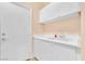 Laundry room with cabinets, utility sink, and exterior access at 31 Castle Creek Ct, Las Vegas, NV 89148